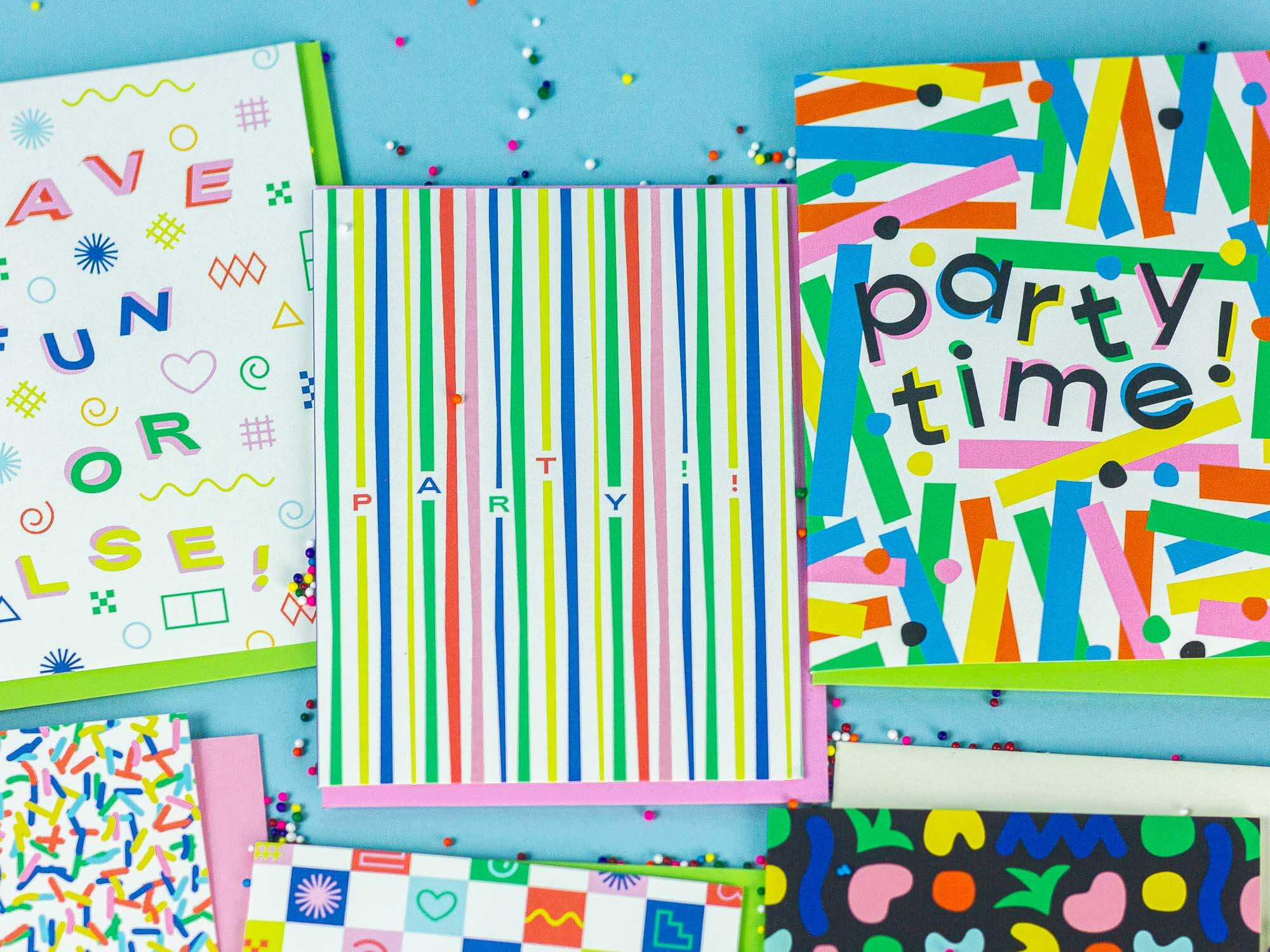 a bunch of party time greeting cards on a table