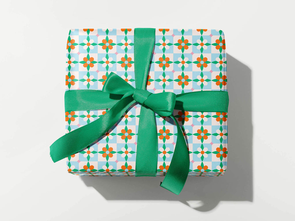 Retro holiday wrapping paper with a vintage-y floral pattern inspired by Spanish Tiles and classic Christmas poinsettias. By @mydarlin_bk