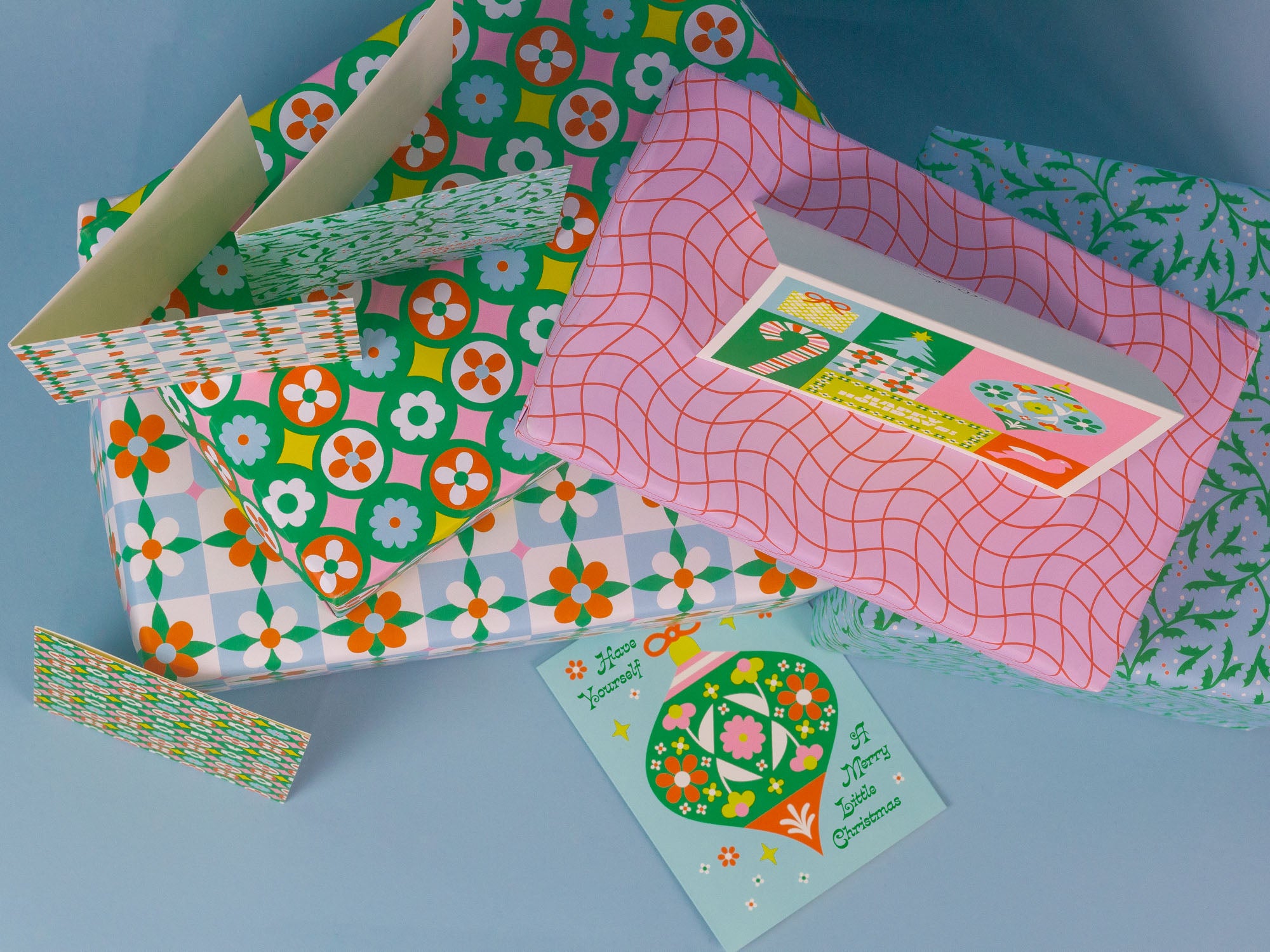 Have Yourself a Merry Little Christmas open holiday card and close up of retro floral Christmas wrapping paper.