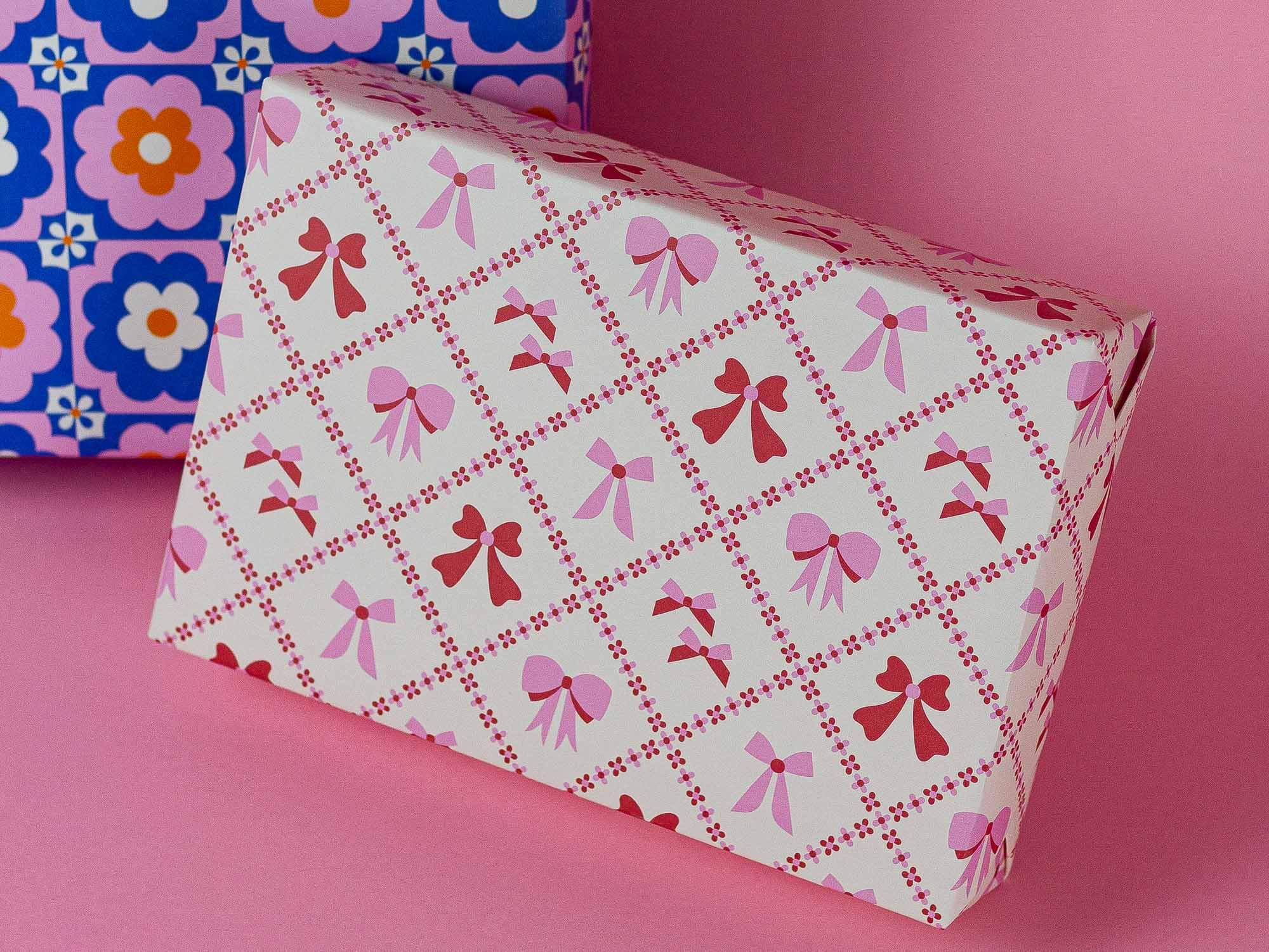 a close up of two boxes on a pink surface