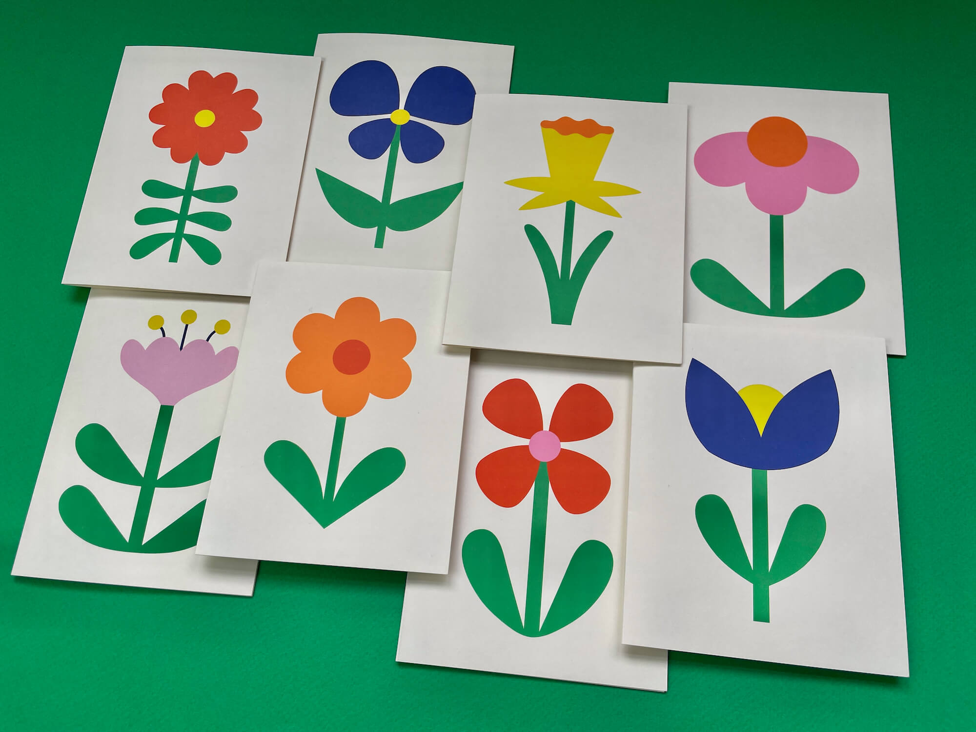 a group of flower cut outs sitting on top of a green table