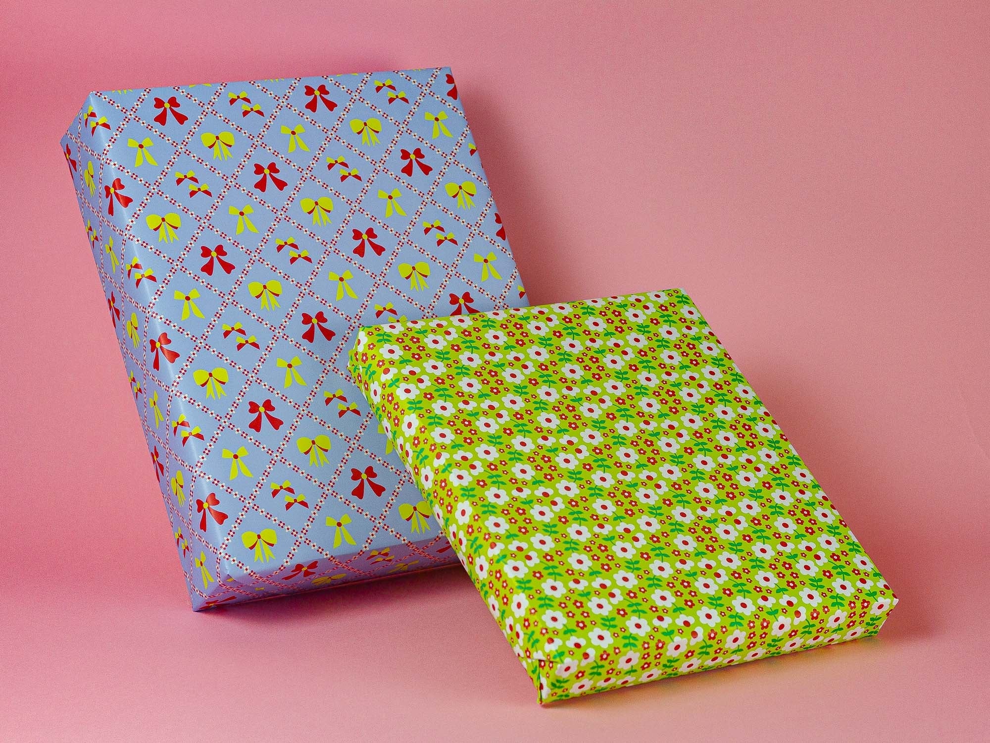 two wrapped presents on a pink background