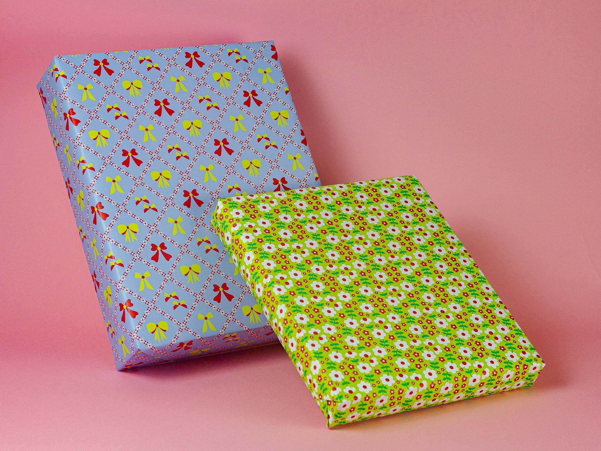 two wrapped presents on a pink background