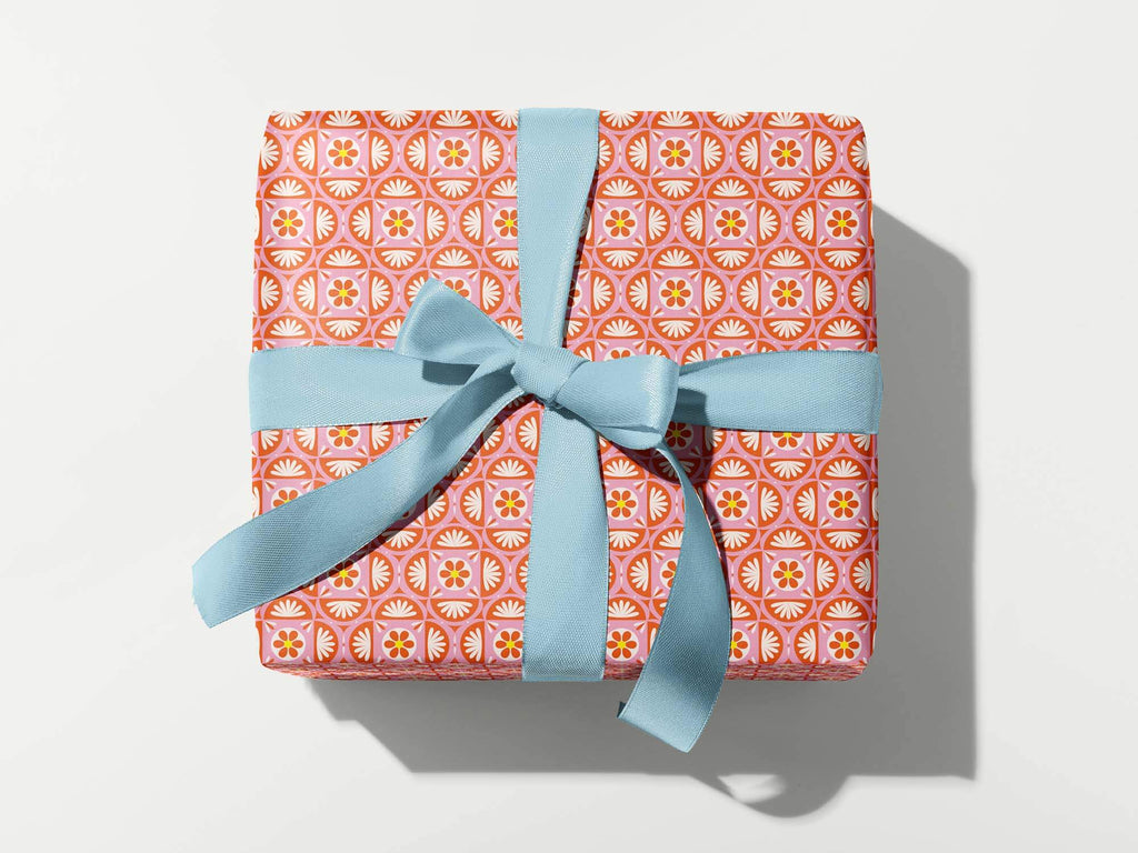 a wrapped gift box with a blue ribbon
