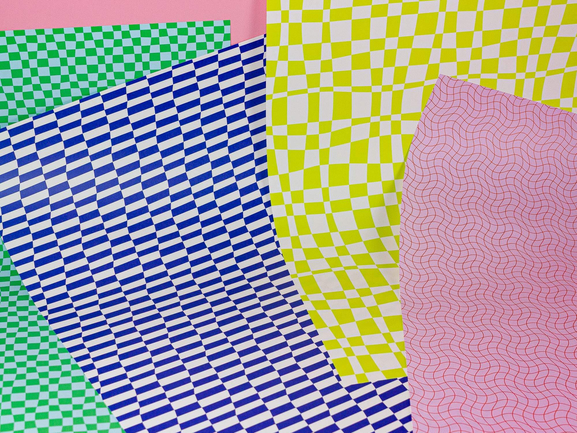 a close up of four different colored papers
