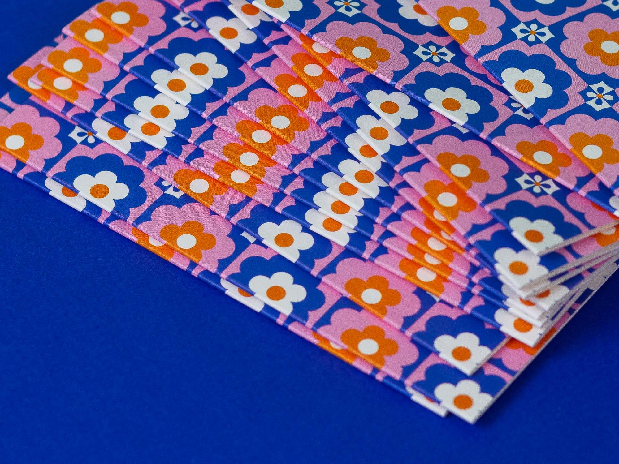 a stack of pink and blue patterned papers