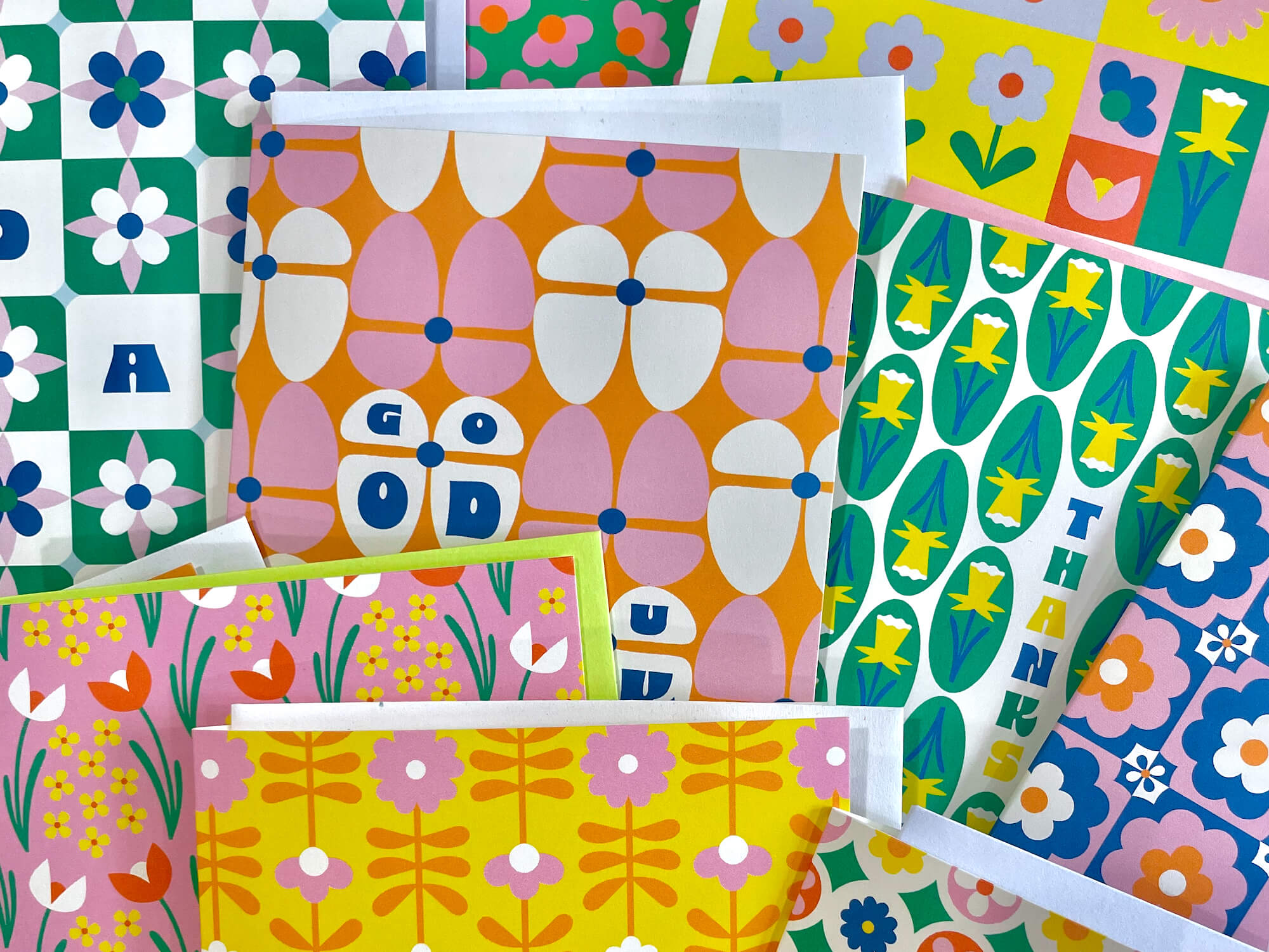 a pile of colorful paper with flowers on them