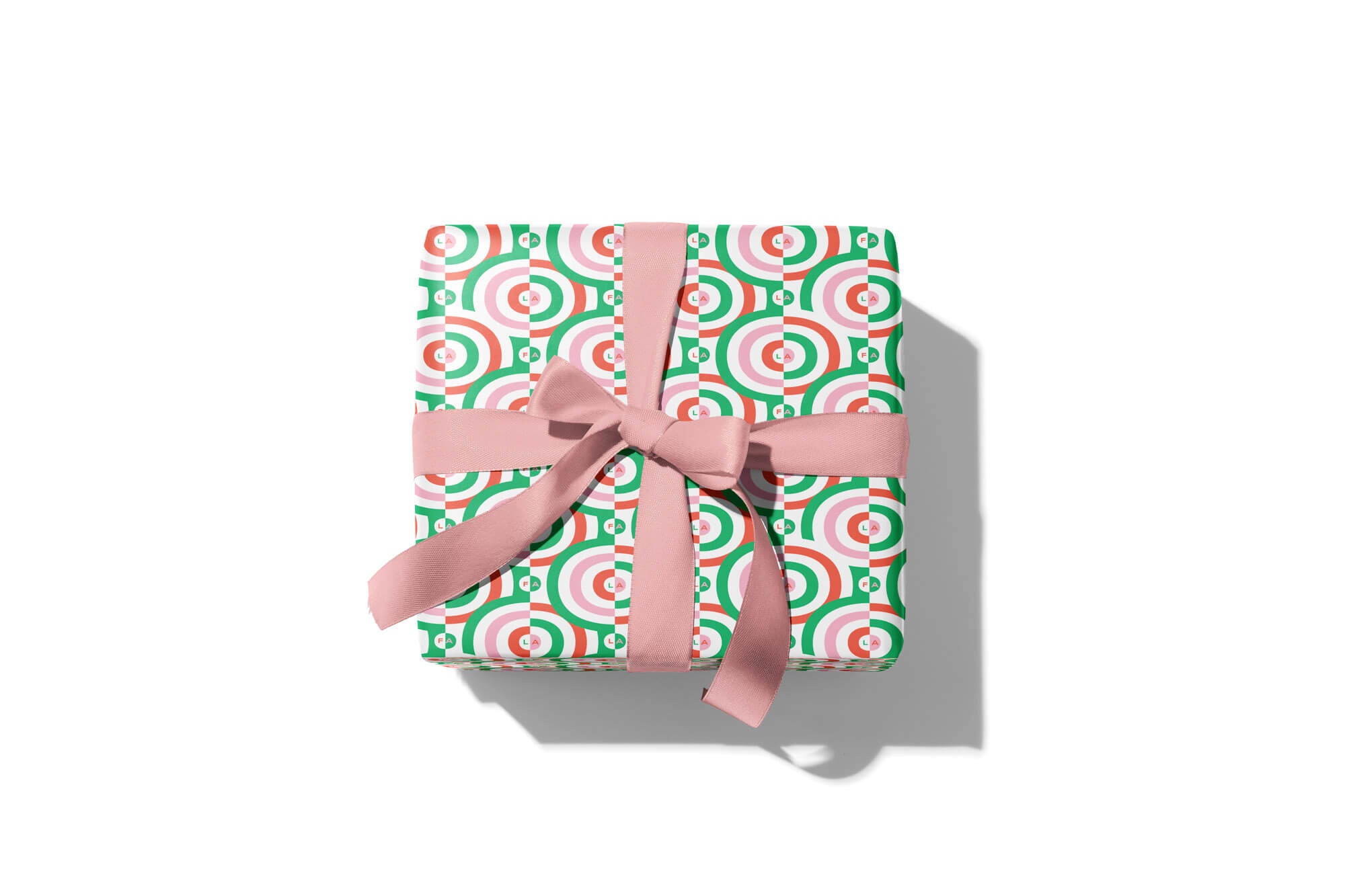 Mid-century and op art inspired pattern wrapping paper made up of hypnotic nested rings and nestled fa la la la las. Colorful, modern, holiday gift wrap with fun prints and patterns by @mydarlin_bk. Made in USA.