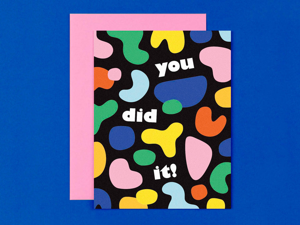 Modern graduation or general congratulations card that reads "you did it!" surrounded by colorful, abstract, blobby shapes. Made in USA by @mydarlin_bk.