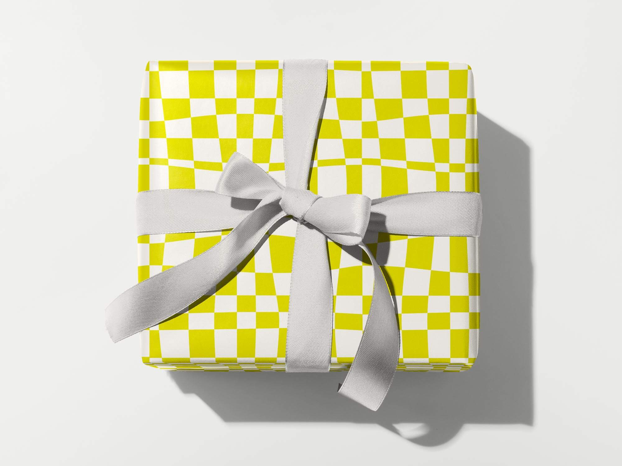 Space Time yellow warped checkerboard pattern wrapping paper. Colorful, modern, gift wrapping sheets with fun prints and patterns by @mydarlin_bk. Made in USA.