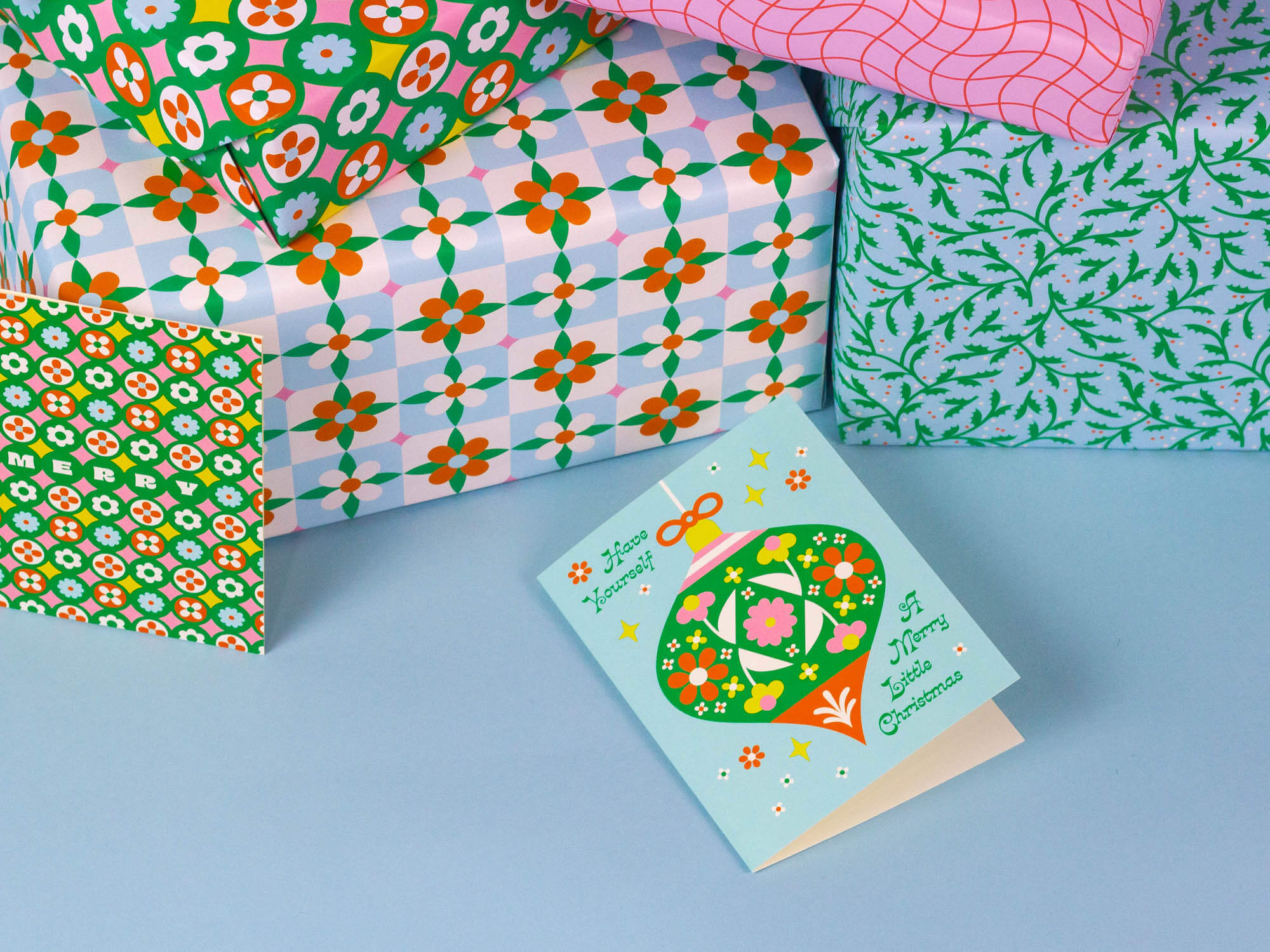 Have Yourself a Merry Little Christmas open holiday card and close up of retro floral Christmas wrapping paper.