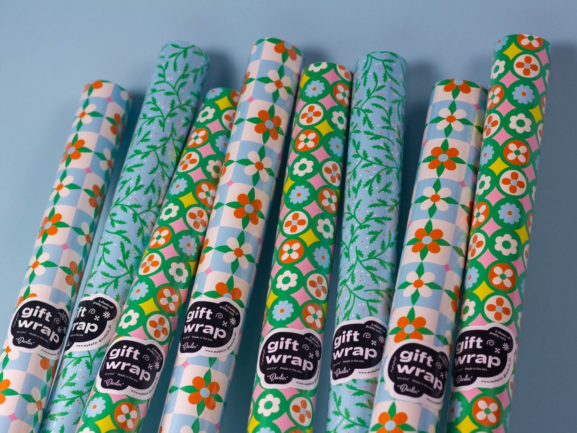 Leaning rolls of retro floral holiday gift wrap by @mydarlin_bk Made in the USA