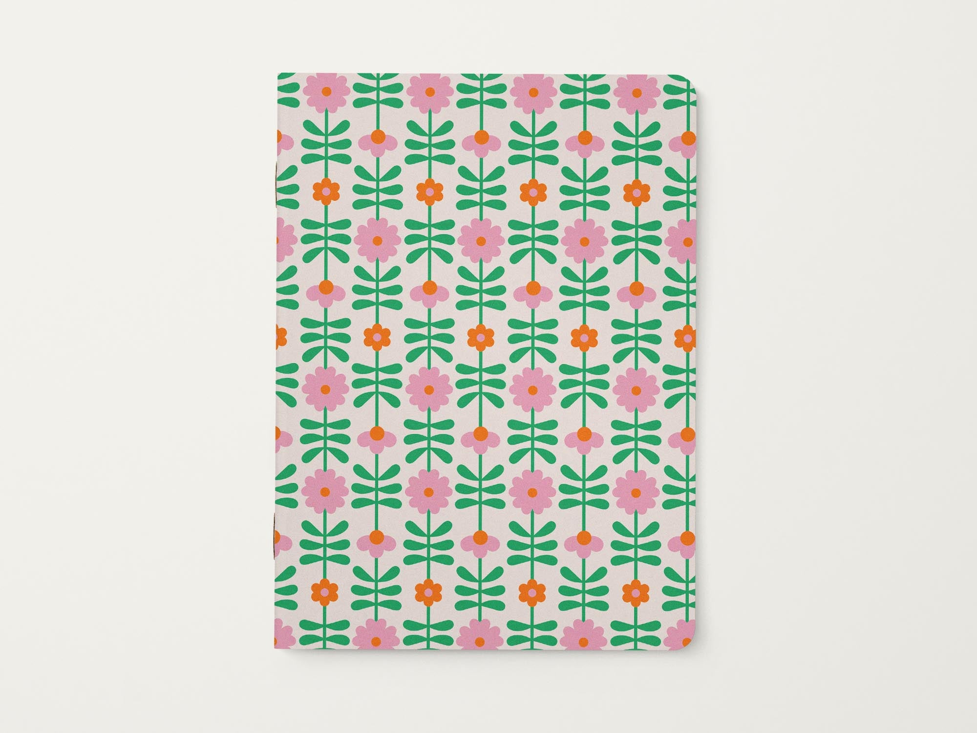 Notebook with a pink and orange retro flower chain or flower tower pattern on a white background