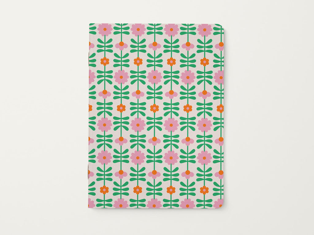 Notebook with a pink and orange retro flower chain or flower tower pattern on a white background