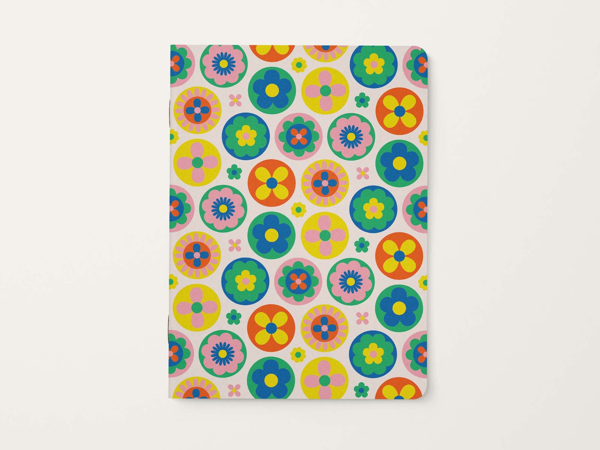 Notebook with colorful retro floral pattern on a white background