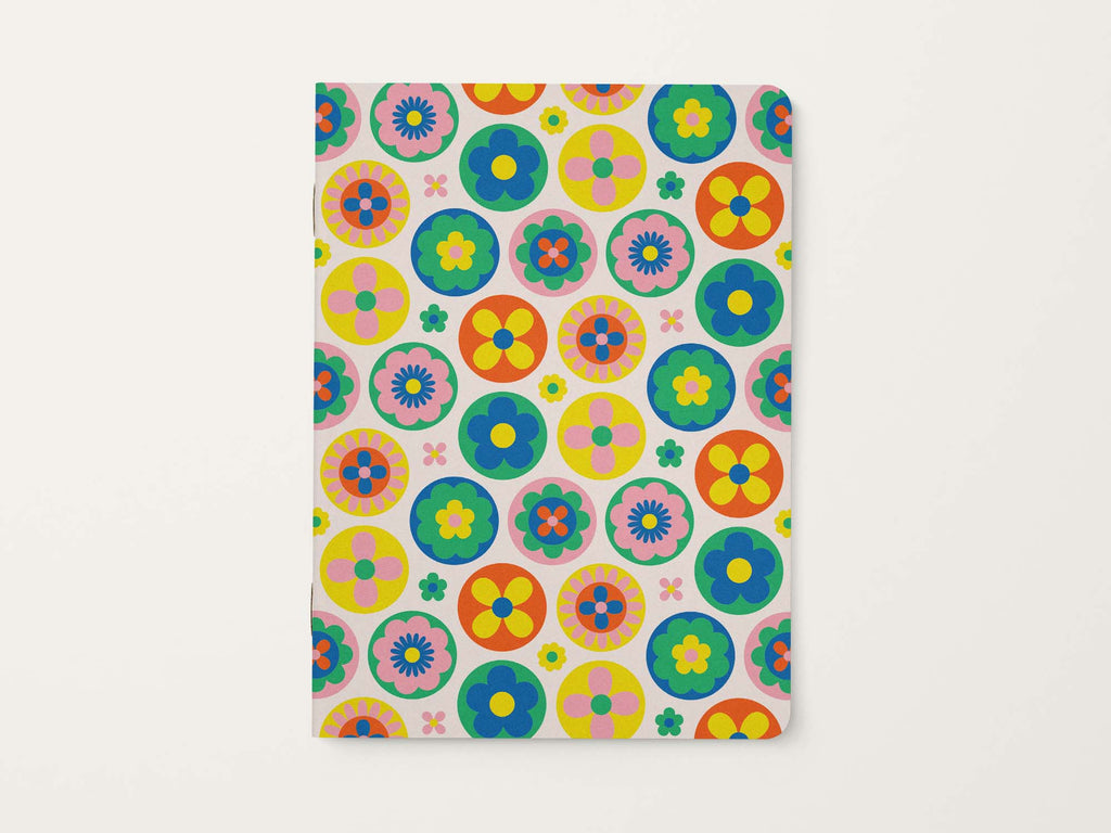 Notebook with colorful retro floral pattern on a white background