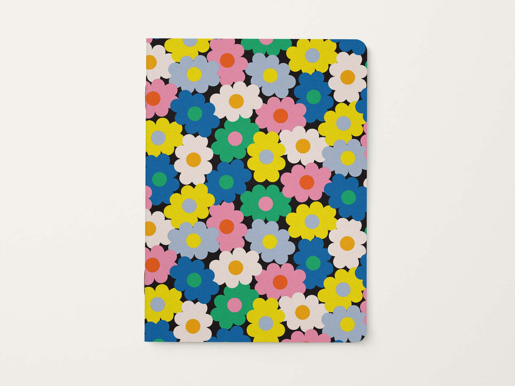 Notebook with colorful vibrant retro floral pattern on a black background

