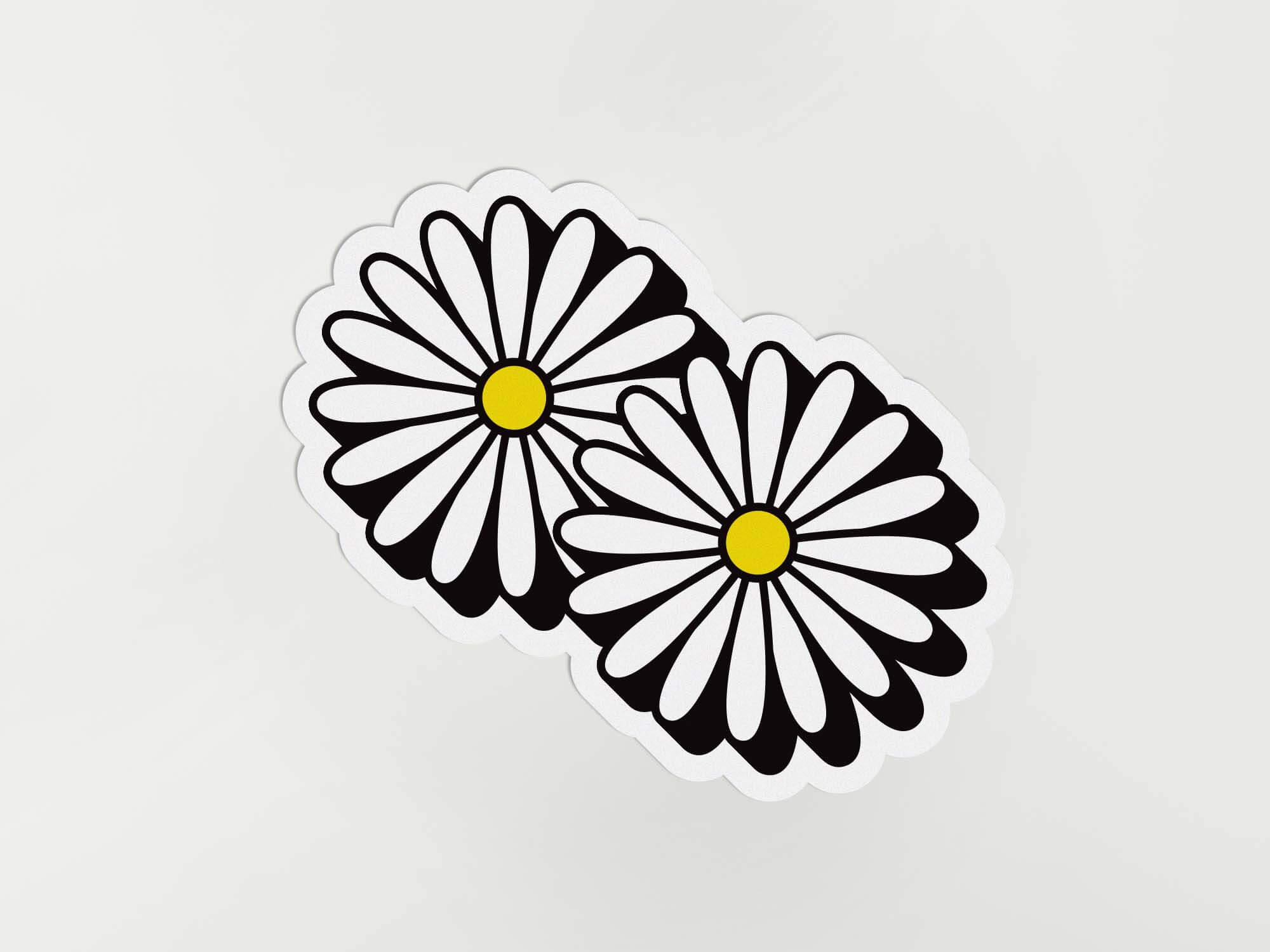 a sticker of three daisies on a white background