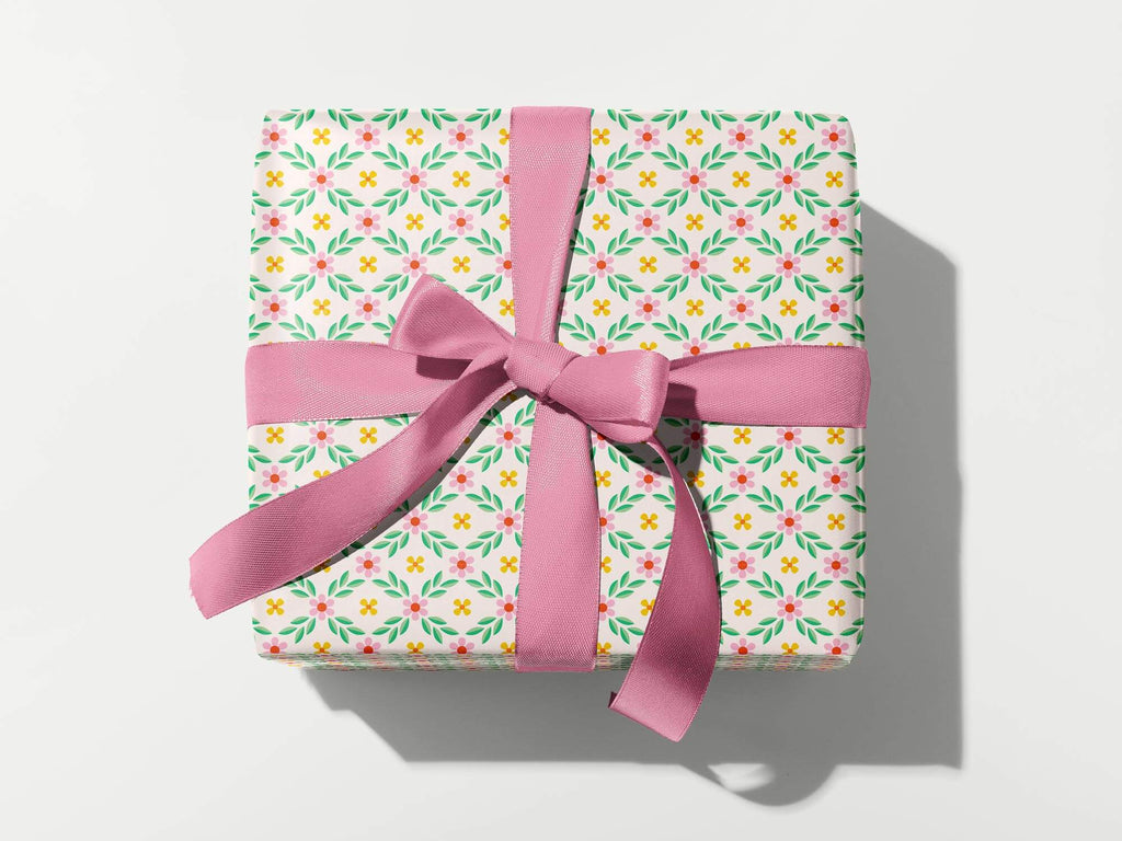 a wrapped gift box with a pink ribbon