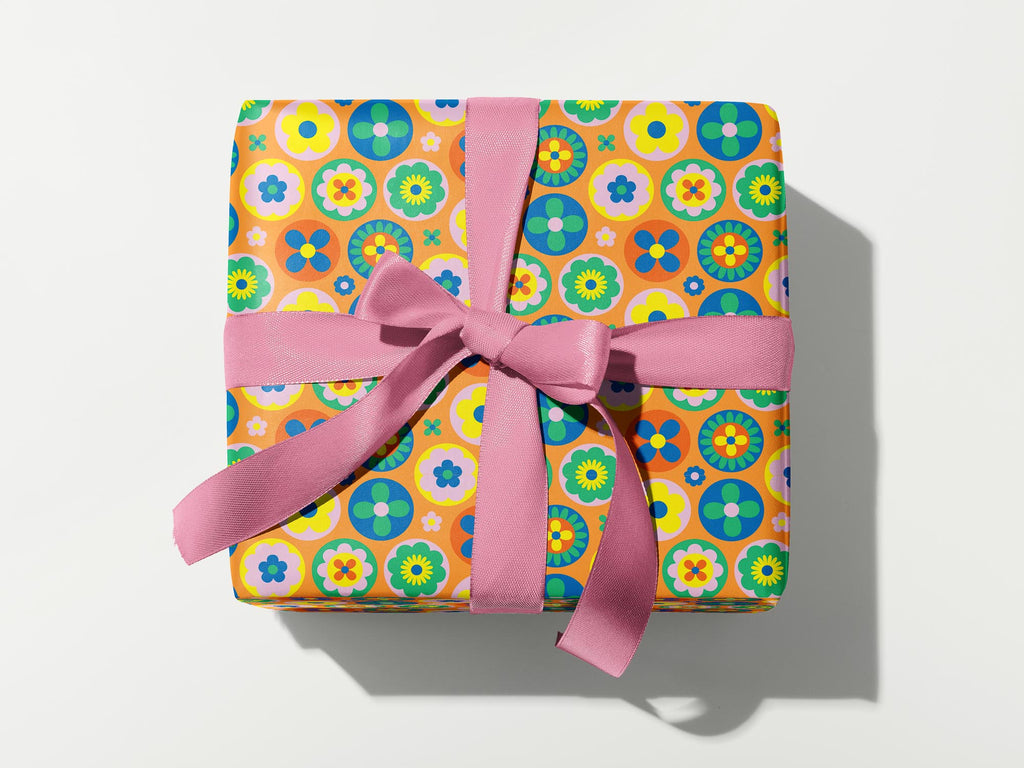 a wrapped gift with a pink ribbon on a white background