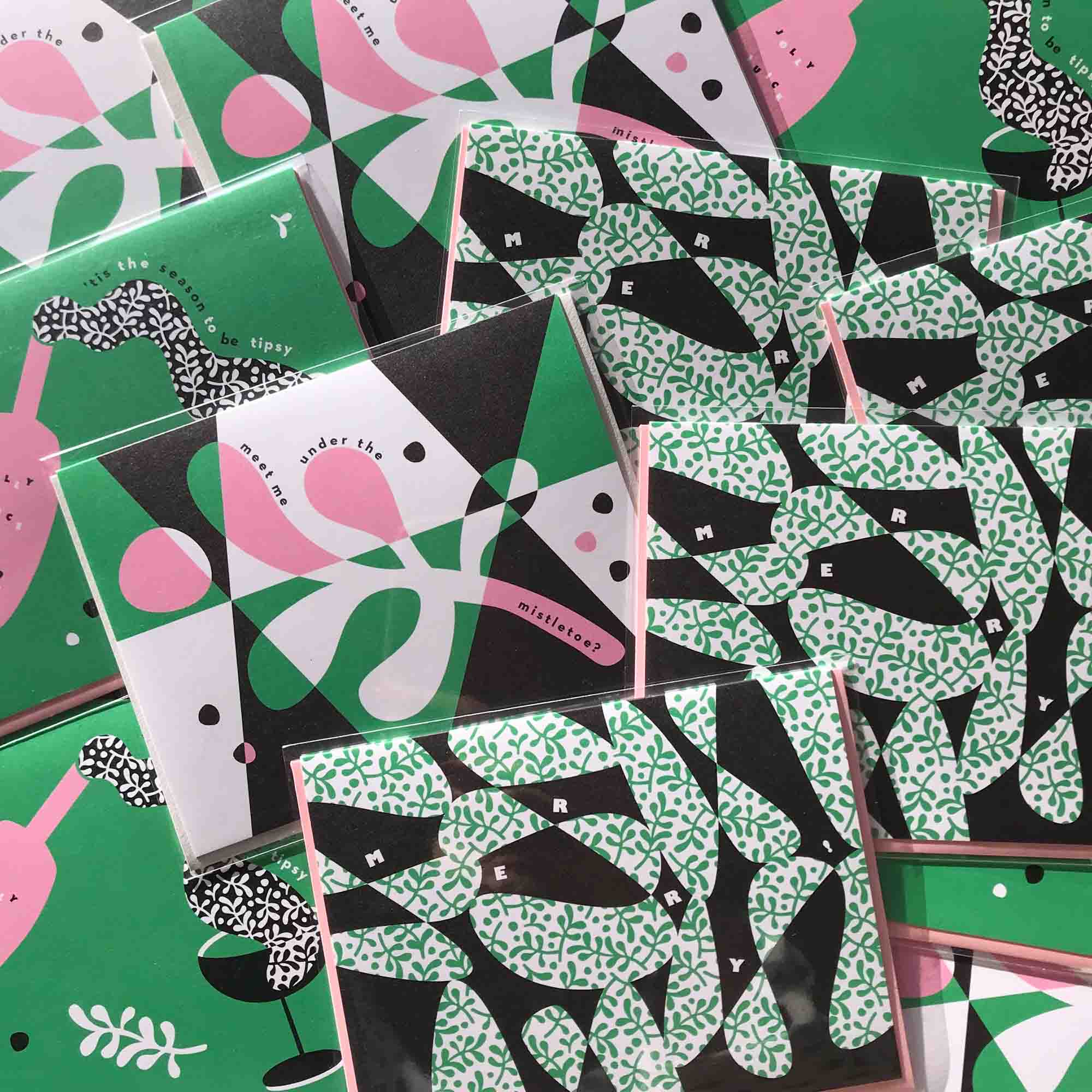 A pile of pink and green retro, mid-century inspired holiday cards by @mydarlin_bk
