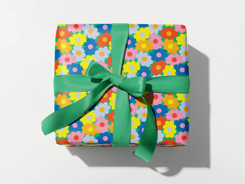 a wrapped gift with a green bow on a white background