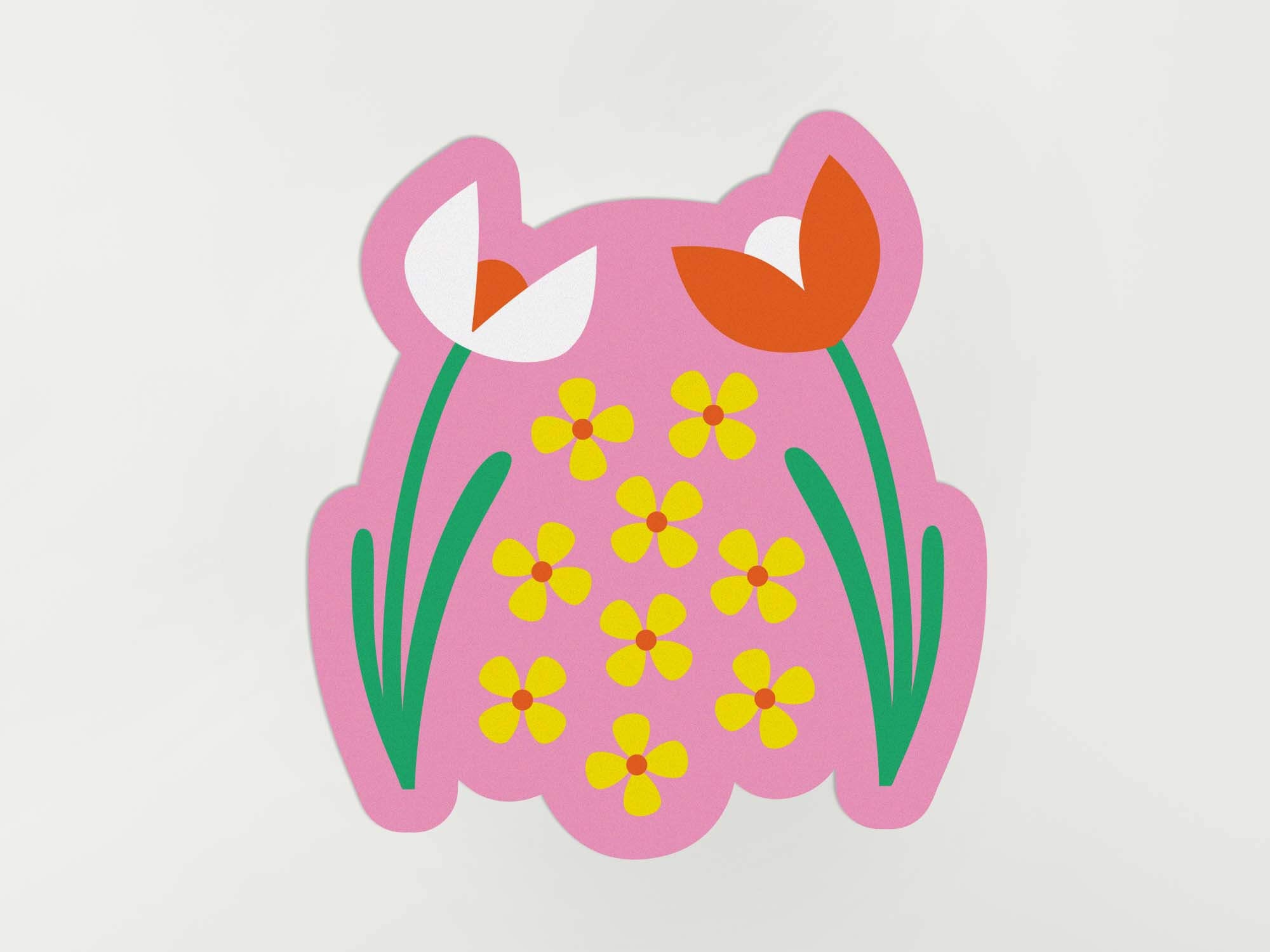 a paper cut out of a pink frog with flowers