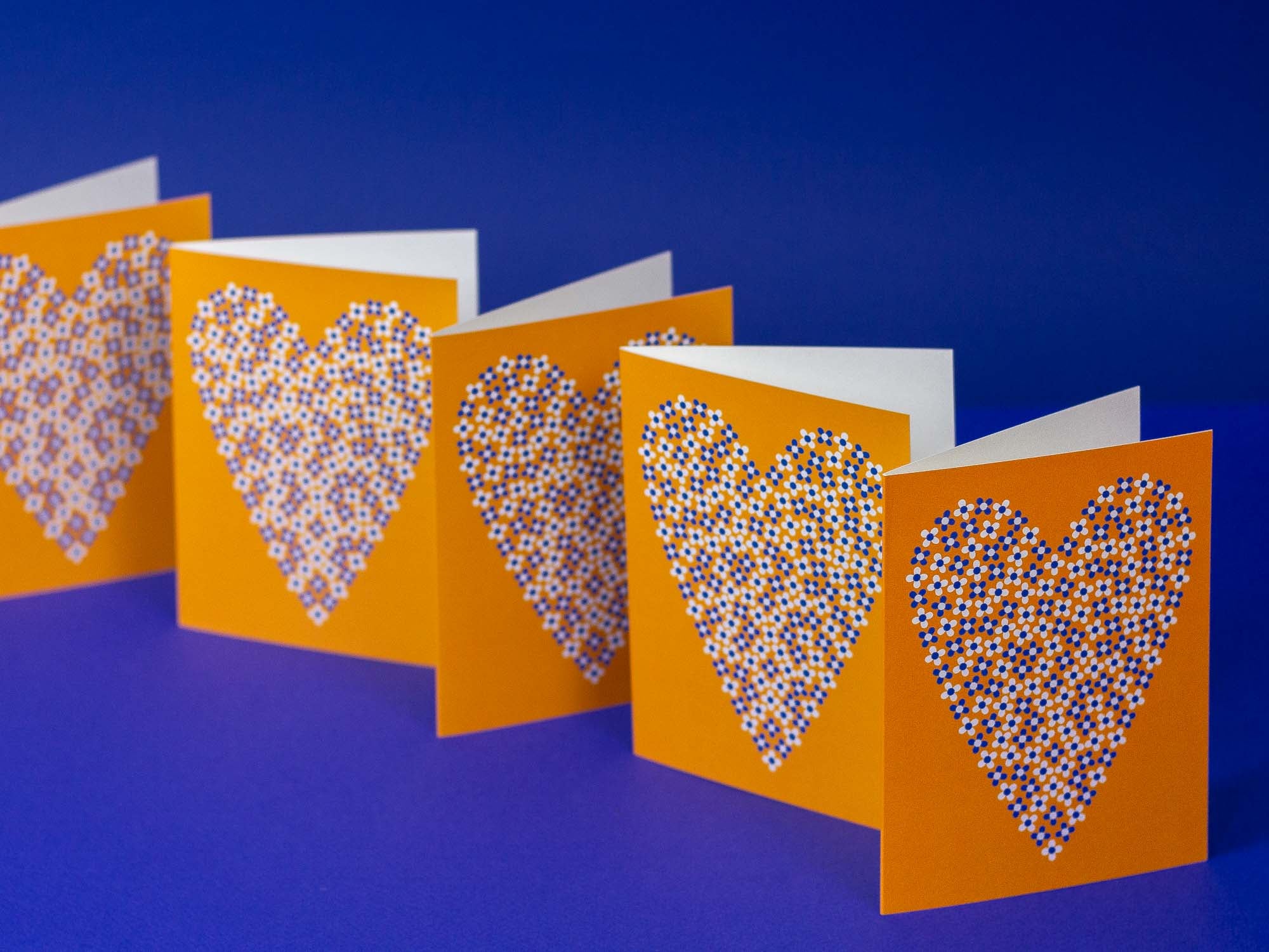 a group of three cards with hearts on them