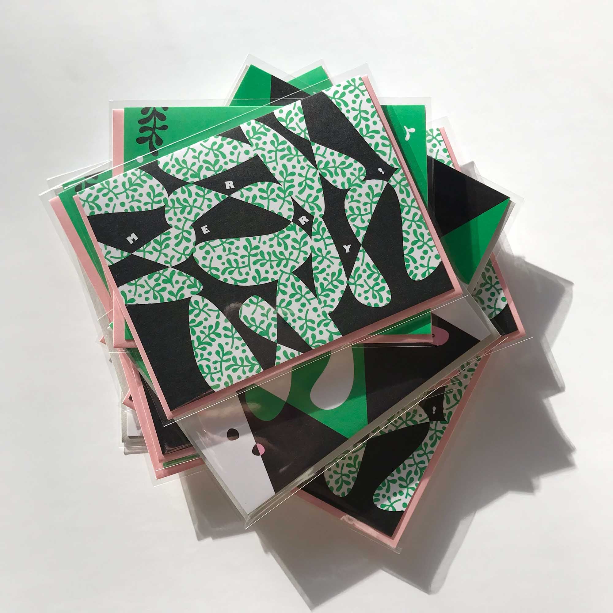 A pile of pink and green retro, mid-century inspired holiday cards by @mydarlin_bk