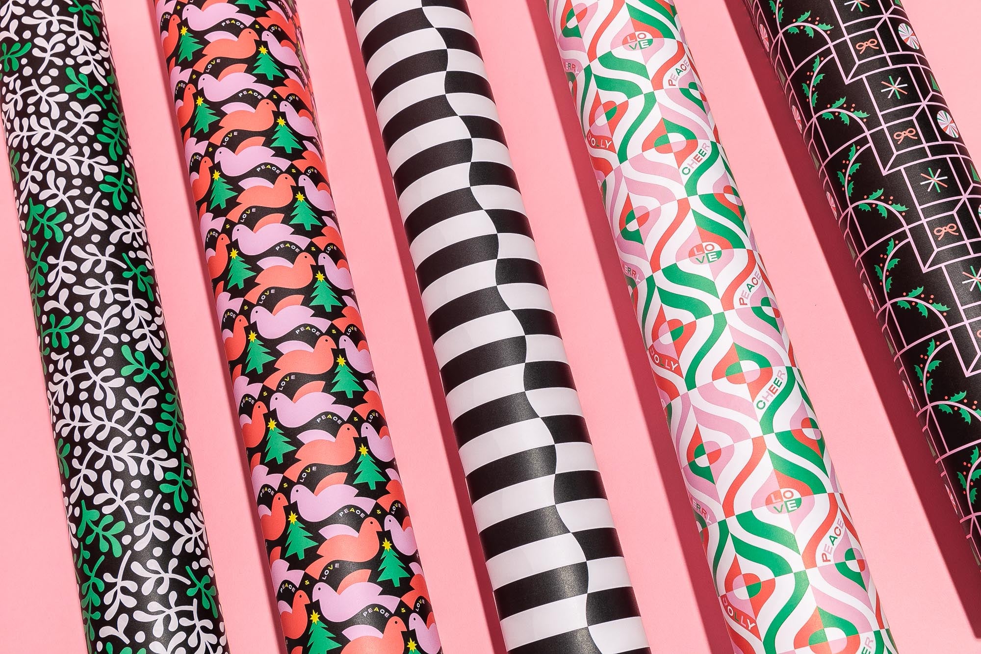 Rolls of cute mid-century inspired Christmas wrapping paper in abstract festive prints and patterns by @mydarlin_bk