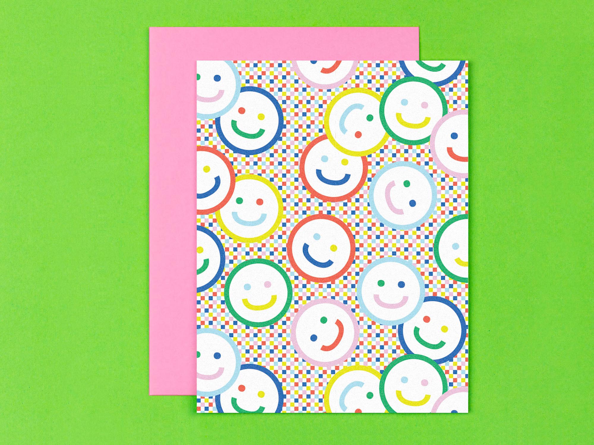 "Check yr smile" blank pattern greeting card with smiley faces against a rainbow checker background. Made in USA by @mydarlin_bk