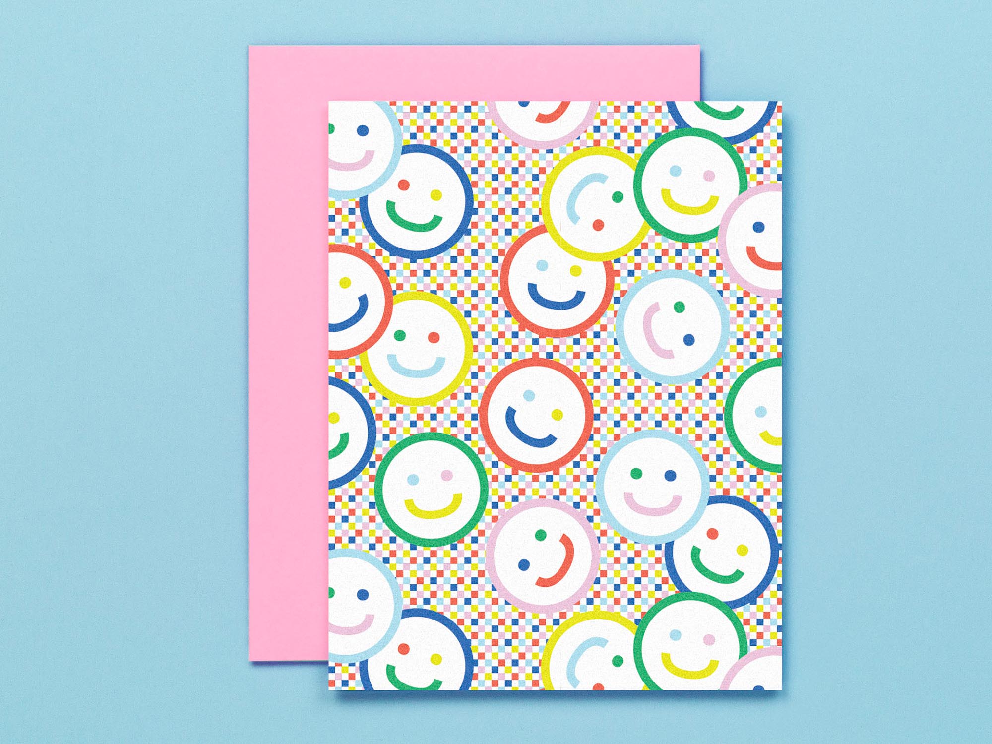 "Check yr smile" blank pattern greeting card with smiley faces against a rainbow checker background. Made in USA by @mydarlin_bk