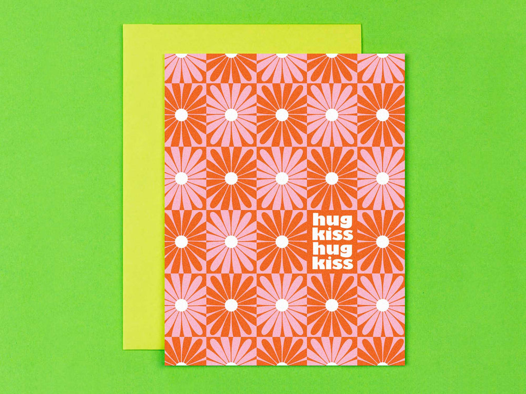 "Hug Kiss Hug Kiss" Hugs and kisses vibrating red and pink checker daisy pattern love, anniversary, or valentine's day card. Vaguely op art inspired. Made in USA by My Darlin' @mydarlin_bk